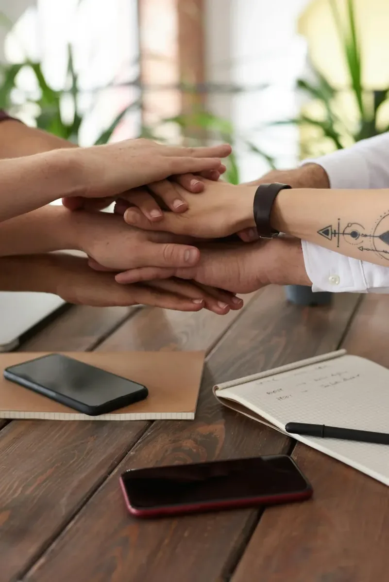 Recruitment consulting team reviewing candidate profiles around conference table